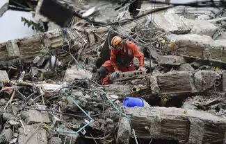 Un integrante de la Brigada Internacional de Rescate Topos Aztecas rescató con vida a un perrito que quedó atrapado entre los escombros
